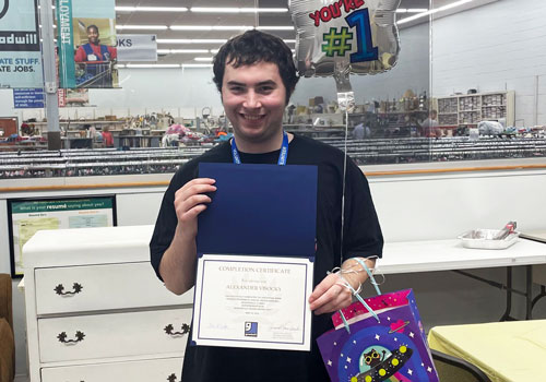 Happy young man graduates from LLGI Vocational Training program.